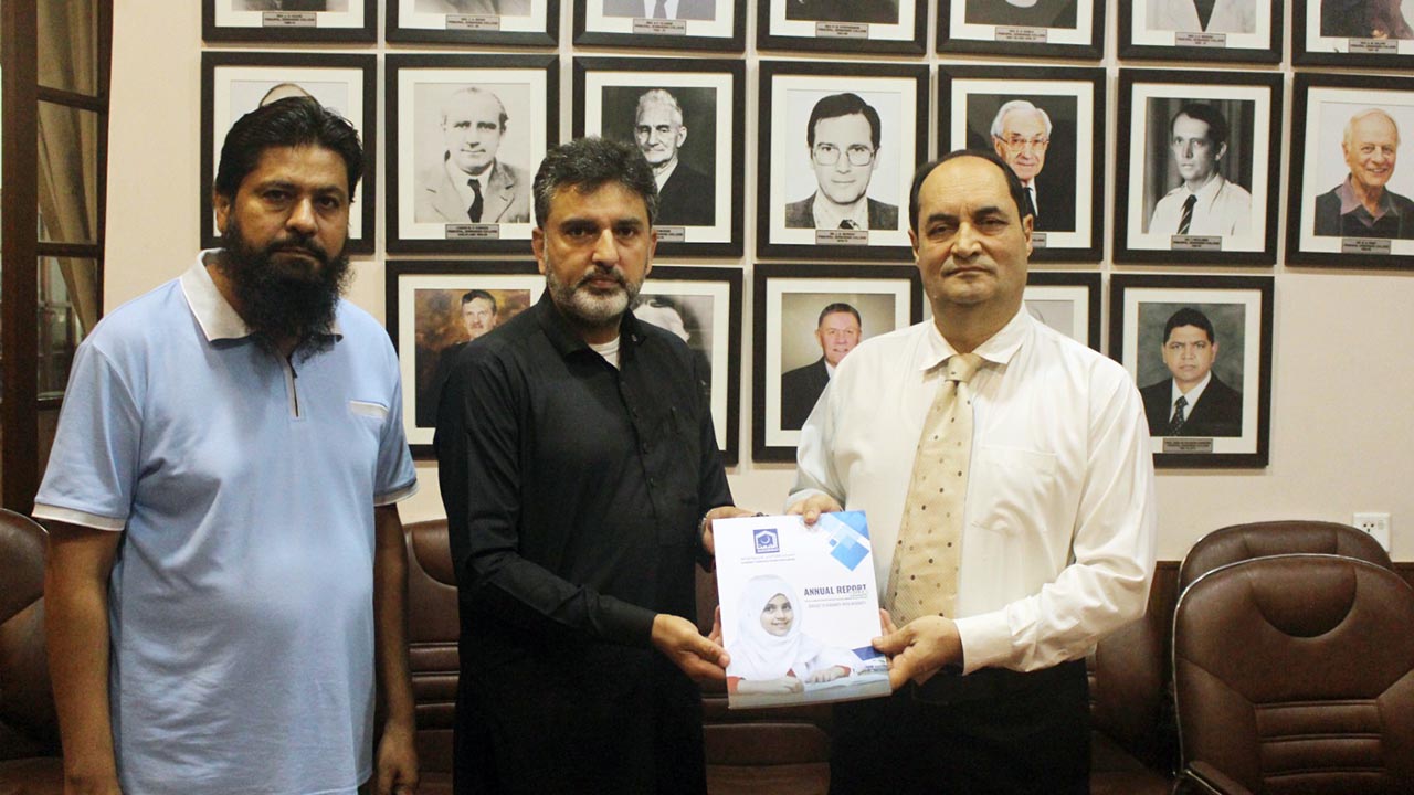 Principal Edwardes College, Peshawar hands over a cheque for the relief of Buner flood affectees to Al Khidmat Foundation